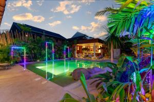 a swimming pool with lights in a house at Palmcove Chiang Mai Old Town in Chiang Mai