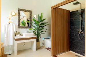 a bathroom with a sink and a toilet and a mirror at Palmcove Chiang Mai Old Town in Chiang Mai +22 photos