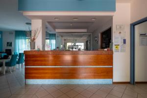 a wooden bar in a restaurant with a counter at Residence Villa Azzurra in Rimini