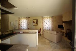 a kitchen with a counter and a couch in a room at gîtes du Cheylard in Les Farges