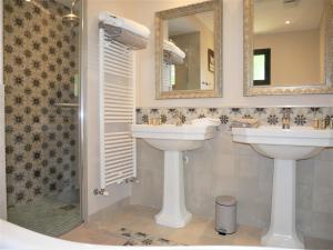 a bathroom with two sinks and a shower at gîtes du Cheylard in Les Farges