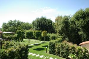 a garden with trees and grass and bushes at gîtes du Cheylard in Les Farges +45 photos