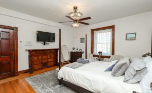 a bedroom with a bed and a flat screen tv at Willough Bed and Breakfast in Conshohocken