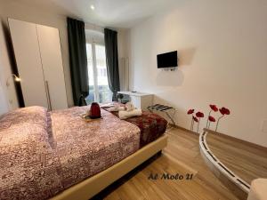 a bedroom with a bed and a tv on the wall at Al molo 21 in La Spezia