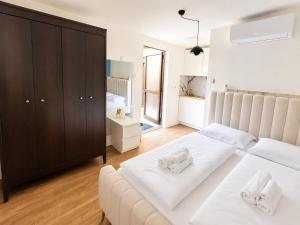 a bedroom with two beds with white towels at Moder Studio Nr15 in Limassol