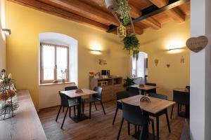 a restaurant with tables and chairs in a room at Palazzo Tamanini in Calceranica al Lago