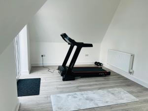 a gym with a treadmill in a room at Luxurious New Home Near Airport in Wythenshawe +32 photos