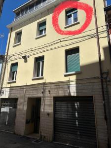a building with a red sign on the side of it at Casa ELLI in Rimini