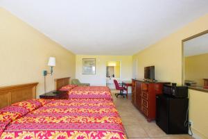 a hotel room with a bed and a desk at Paramount Lakeside Inn & Suites in Lakeland