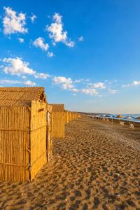 a row of fences on a sandy beach at Espace Azaimi in Tarîfa