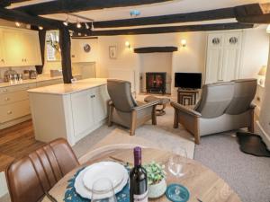 a kitchen and living room with a table and chairs at The Toll Bar in Castleton