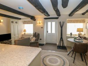 a kitchen and living room with a table and chairs at The Toll Bar in Castleton