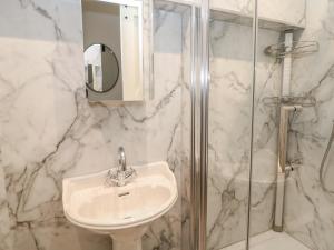 a white bathroom with a sink and a shower at The Toll Bar in Castleton +21 photos