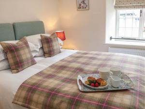a tray of food sitting on top of a bed at The Toll Bar in Castleton