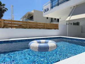 a swimming pool with a bean bag chair in the water at OLIA STUDIOS Olga studios in Faliraki