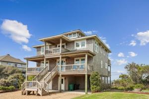a large house with balconies and stairs on it at Knot for Sail in Duck