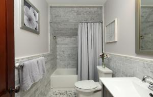 a bathroom with a white toilet and a tub and a sink at Willough Bed and Breakfast in Conshohocken +59 photos