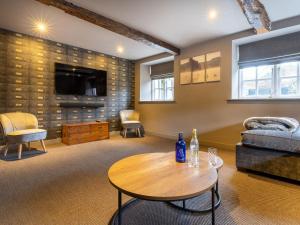 a living room with a table and a couch at Prospect House in Windermere
