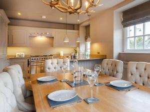 a kitchen and dining room with a wooden table and chairs at Prospect House in Windermere +38 photos