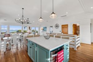 a kitchen and living room with a island and a dining room at Sanctuary in Duck