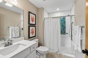a bathroom with a toilet and a sink and a shower at Sanctuary in Duck +43 photos
