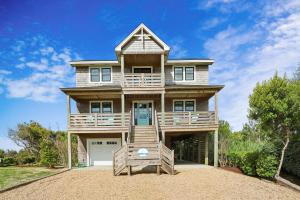 a large house with a porch and a balcony at Sanctuary in Duck