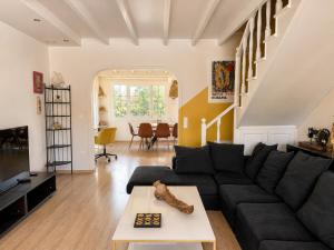 a living room with a couch and a table at Virginia's Penthouse in Kassiopi