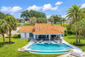 an aerial view of a house with a swimming pool at SWISS 101 - Lake Olsen in Clermont
