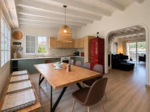 a kitchen and dining room with a wooden table and chairs at Virginia's Penthouse in Kassiopi