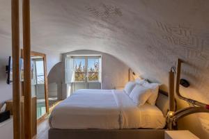 a bedroom with a bed and a window at Santorini Soul Villas in Pyrgos +82 photos