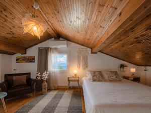 a bedroom with a large bed with a wooden ceiling at Virginia's Penthouse in Kassiopi +25 photos