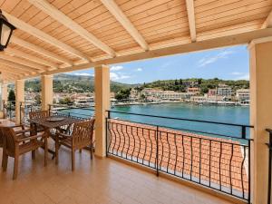 a balcony with a table and chairs and a view of the water at Virginia's Penthouse in Kassiopi
