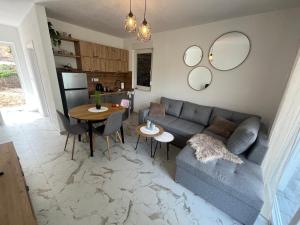 a living room with a couch and a table at Holiday Home Paradise in Prozor