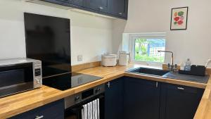 a kitchen with a sink and a microwave at Builth wells stay in Builth Wells +12 photos