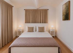 a bedroom with a large bed with two tables at Urban Base CELJE in Celje