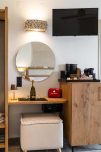 a room with a desk and a mirror at Iliovasilema Studios in Mytakas +52 photos