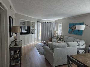 a living room with a couch and a table at Tidewater Star Unit 2i in Duck