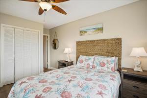 a bedroom with a bed and a ceiling fan at Tidewater Star Unit 2i in Duck +28 photos