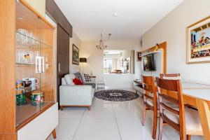 a kitchen and living room with a table and chairs at Apto com conforto que você precisa. in Goiânia