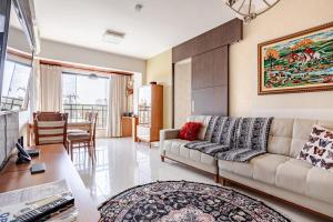 a living room with a couch and a table at Apto com conforto que você precisa. in Goiânia