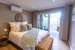 a bedroom with a bed and a sliding glass door at The Palm Suites in Meadowridge