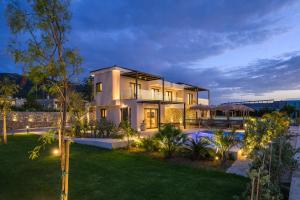 a large house with lights in the yard at Mama Rosa Luxury Villas with private pools in Zipárion