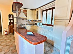 a kitchen with white cabinets and a counter top at Villa La Terrazza in Porto Santo Stefano