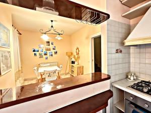 a kitchen with a table and a dining room at Villa La Terrazza in Porto Santo Stefano +18 photos