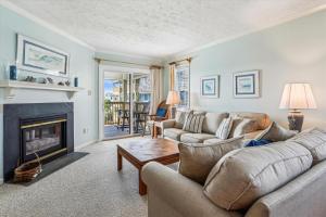 a living room with a couch and a fireplace at Duck Legacy Unit 2E in Duck