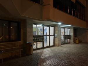 an empty hallway of a building with glass doors at View of the forest in Veliko Tŭrnovo