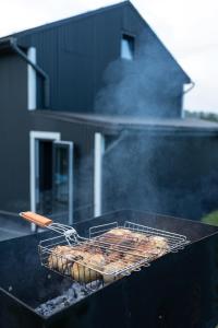 a grill with some food cooking on top of it at Horizon Славсько з чаном,басейном in Khashchovanoye