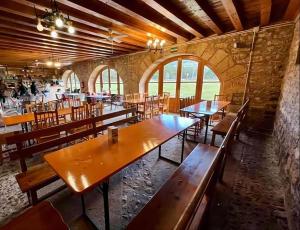 a dining room with wooden tables and chairs at Nuestra Señora de Revenga in Regumiel de la Sierra