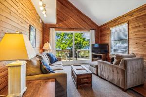 a living room with a couch and a television at Emerald Duck in Duck