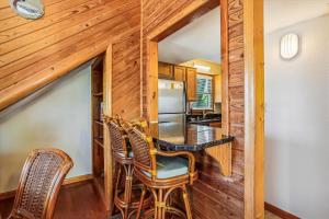 a dining room with a table and chairs in a house at Emerald Duck in Duck +18 photos
